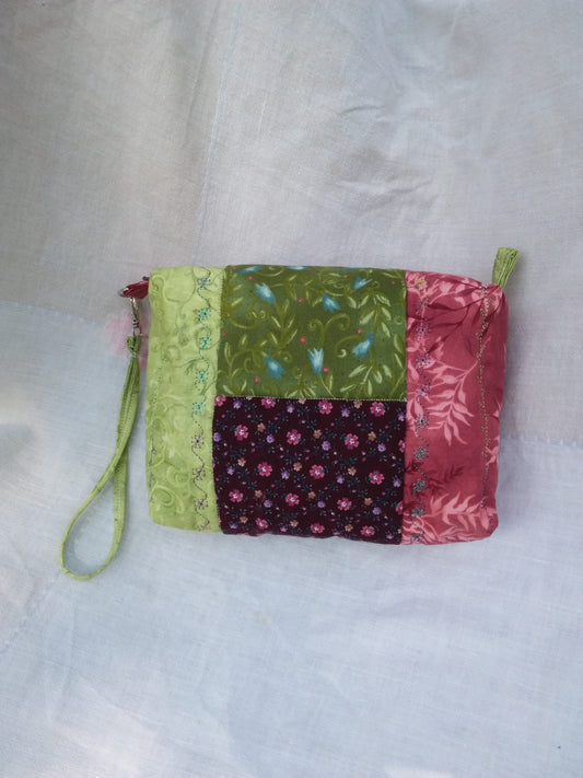A small Cottage Core purse with a patchwork of vintage, upcycled fabrics.