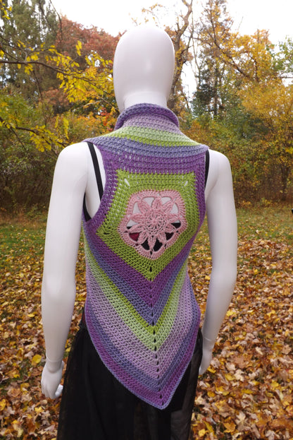A crochet crop top vest with lotus flower design in shades of green, purple and pink.