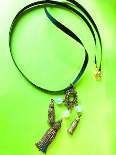 Gold tone large filigree pendant on silk ribbon necklace
