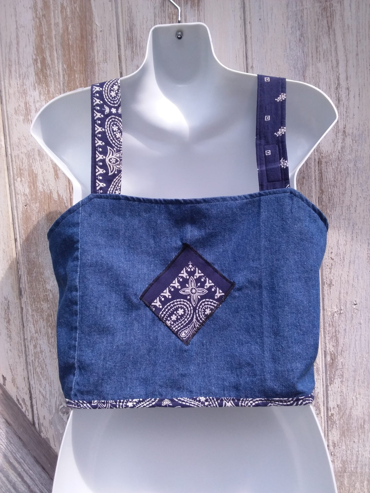 An upcycled denim top with a bandana on it.