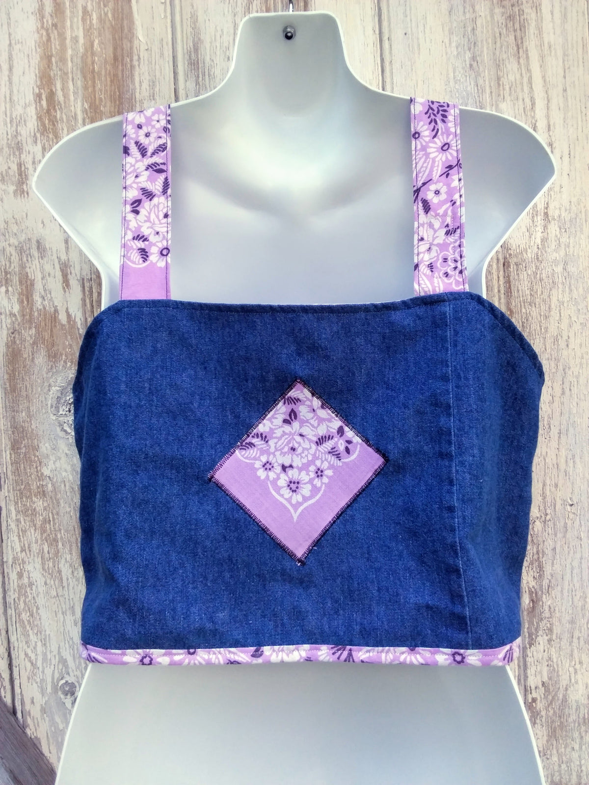 A mannequin with an upcycled denim top and purple bandana fabric.