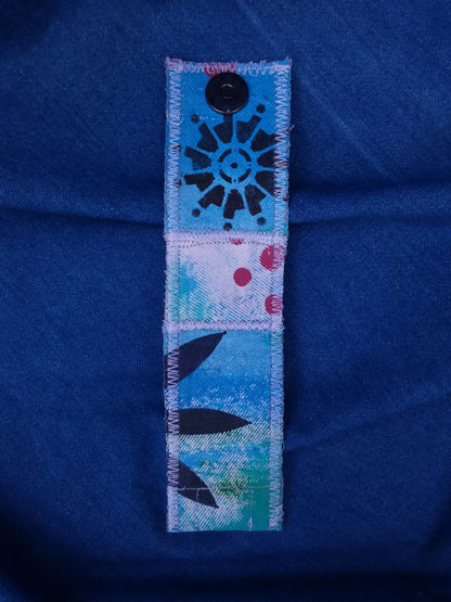 A painted cuff bracelet of recycled denim