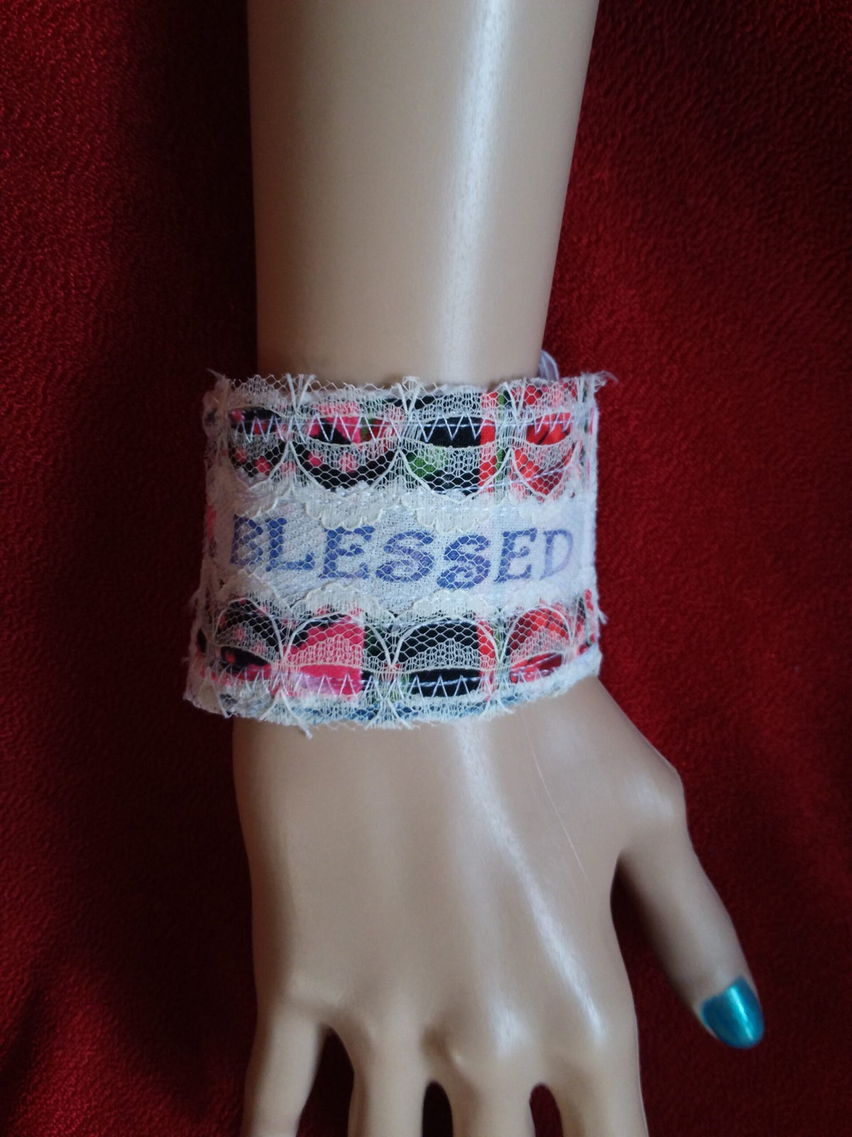 A mannequin wearing a bracelet that says blessed.