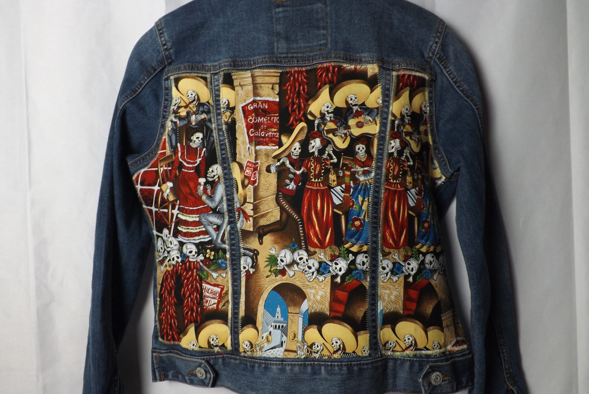 A denim jacket with calavera skeleton fabric quilted on it
