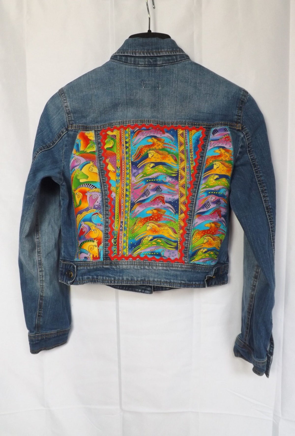 A thrifted denim jacket with Laurel Burch horse fabric and red trim.