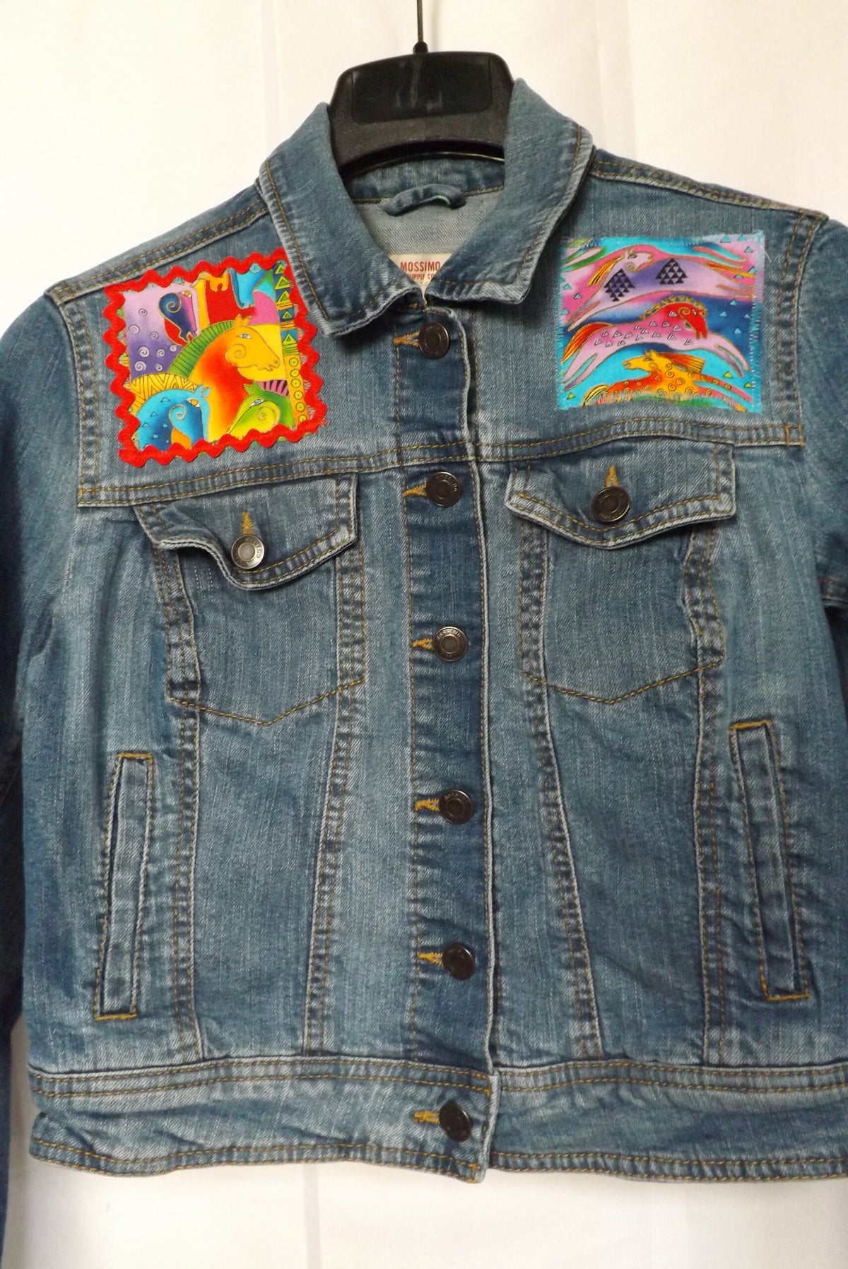 A thrifted denim jacket with sewn on patches