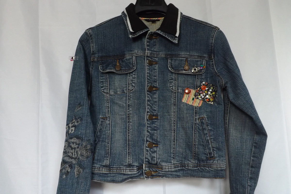 A denim jacket with patches and rhinestones