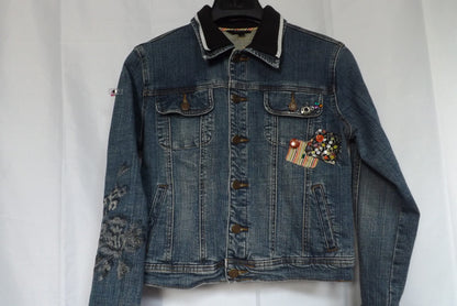 A denim jacket with patches and rhinestones