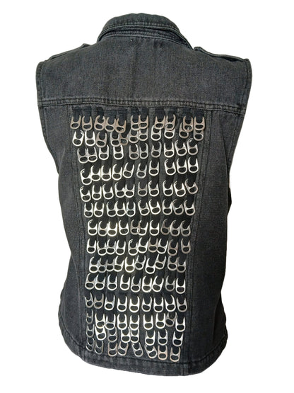 A denim vest adorned with numerous silver-colored pull tabs creating a pattern on the back.