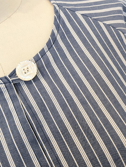 A close up of a blue and white striped shirt on a mannequin.