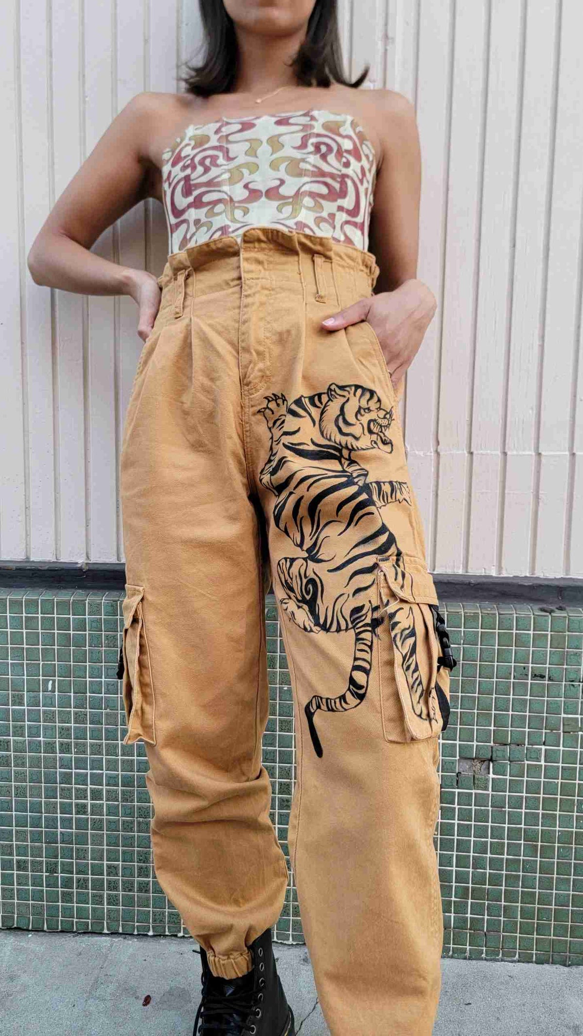 a woman wearing tiger print pants and a tank top.