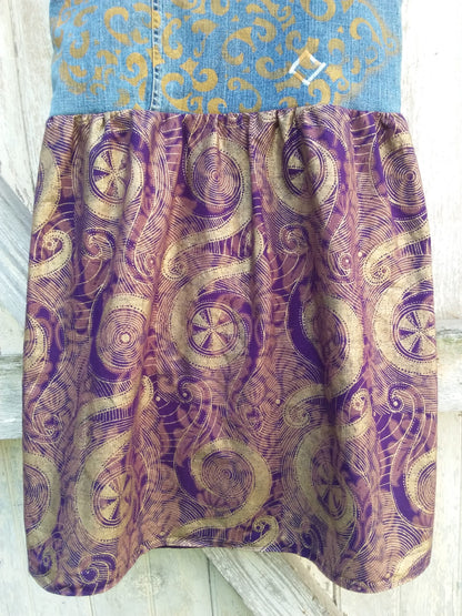 a denim dress with purple and gold paisley print.