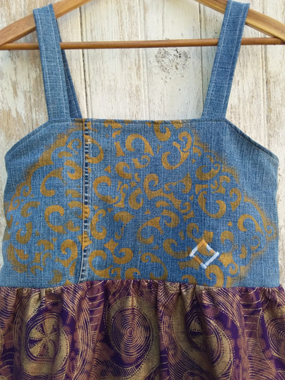 a denim dress with a gold and purple pattern.