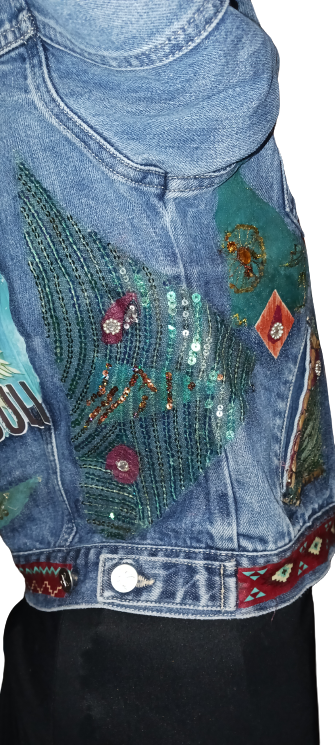 A woman wearing a denim jacket with sequins on it.