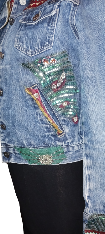 A woman wearing a denim jacket with sequins on it.