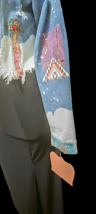 A blue jacket with a picture of a santa claus on it.