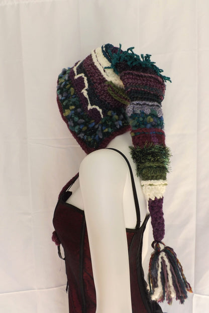 A mannequin wearing a knitted hat and scarf.