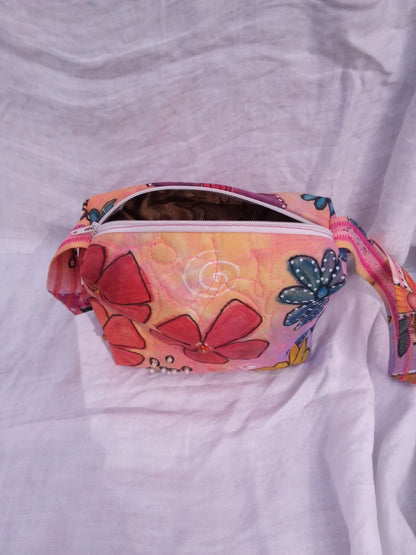 A hand dyed and painted purse with bold flowers, beads and quilting.