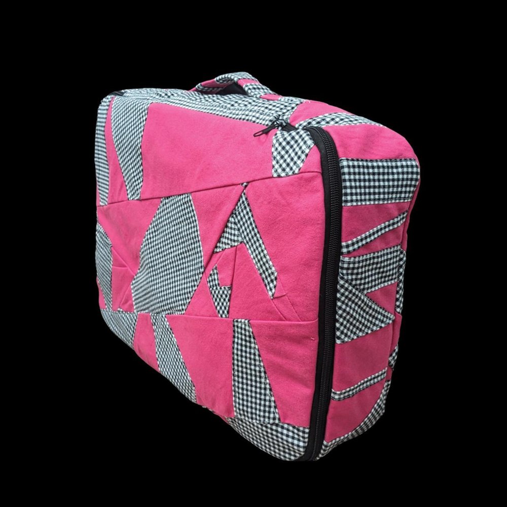 A pink suitcase with black and white checkered pattern.
