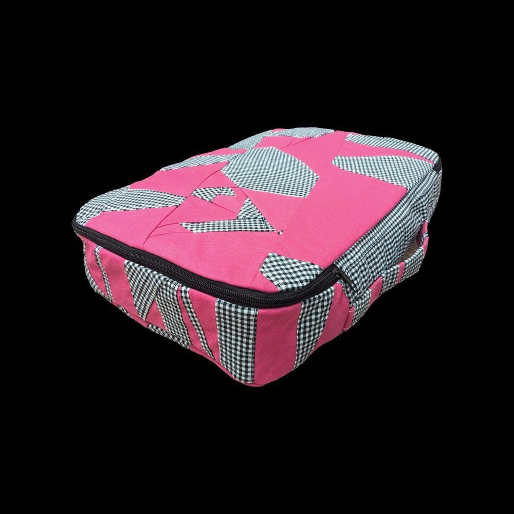 A pink and black bag with a checkered pattern.
