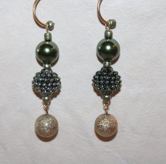 A pair of earrings with beads in the shape of little balls.