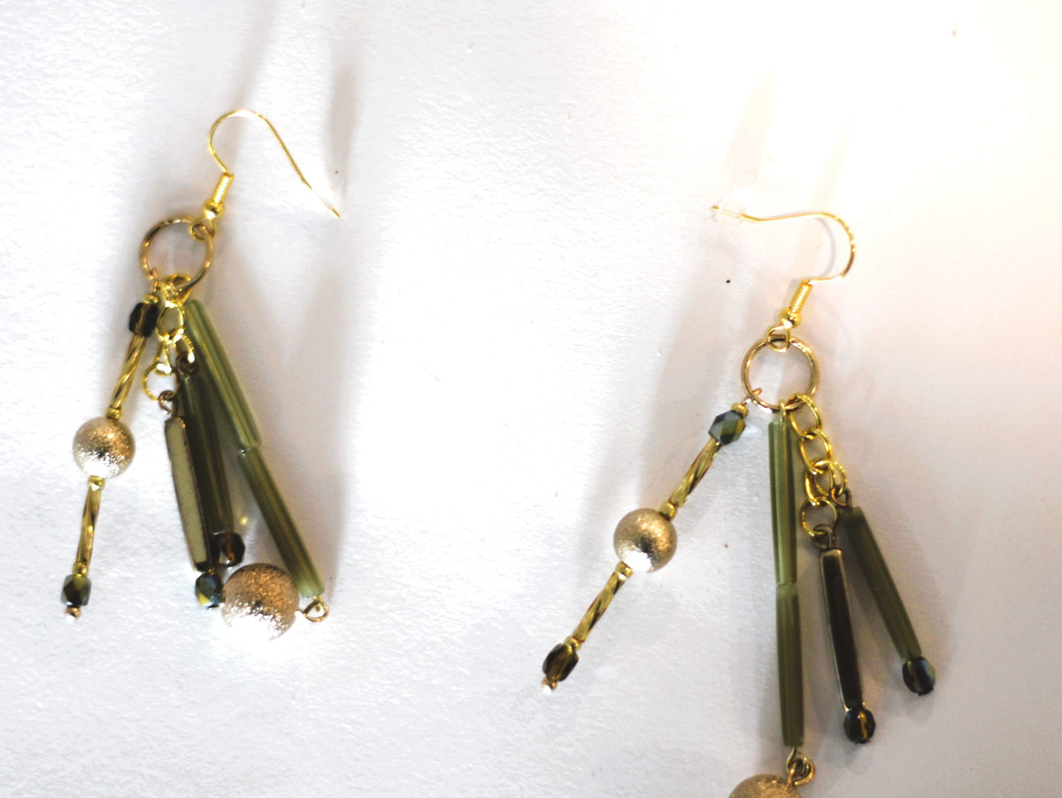 A pair of gold dangling earrings.