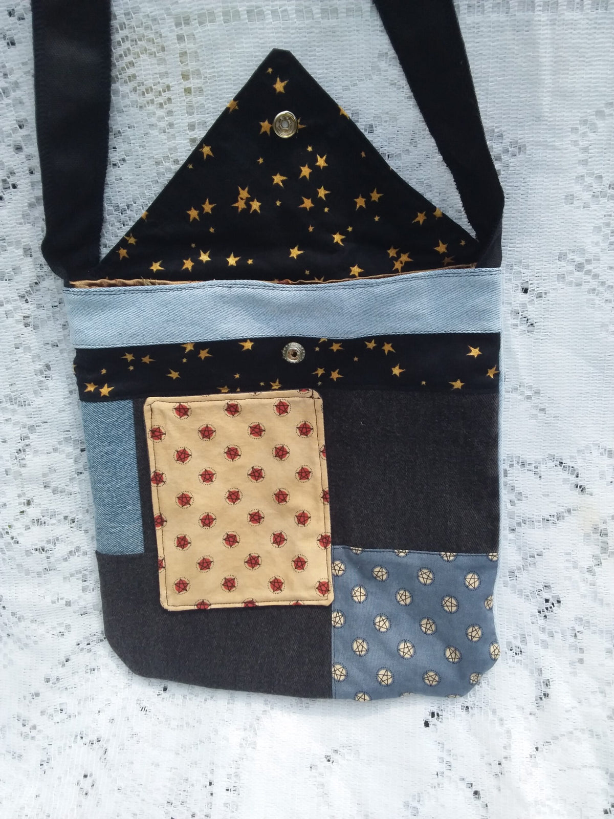 Upcycled denim and vintage fabric combine in this artisan crafted designer handbag