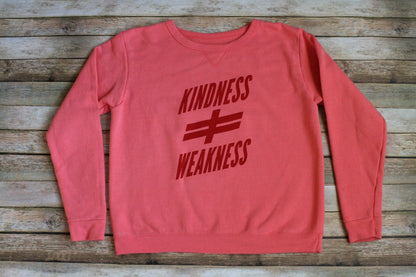A pink sweatshirt with the words kindness and weakness on it.