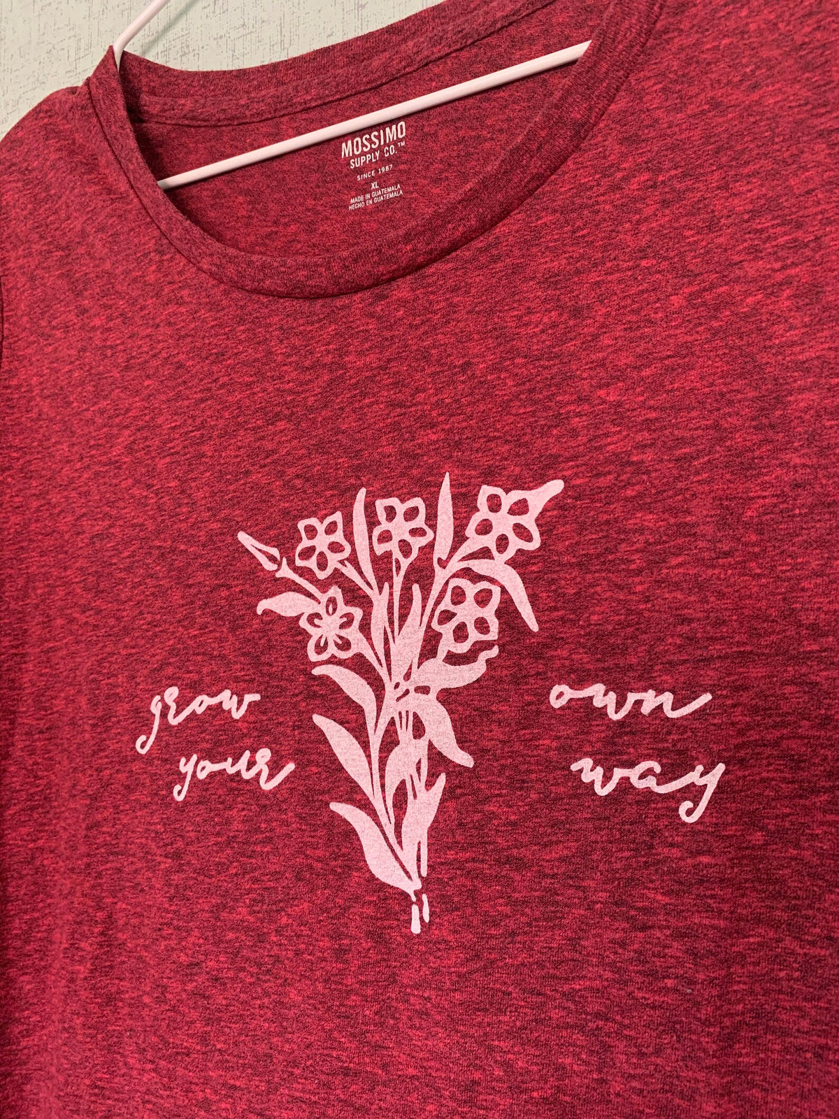 A red t - shirt with flowers on it.