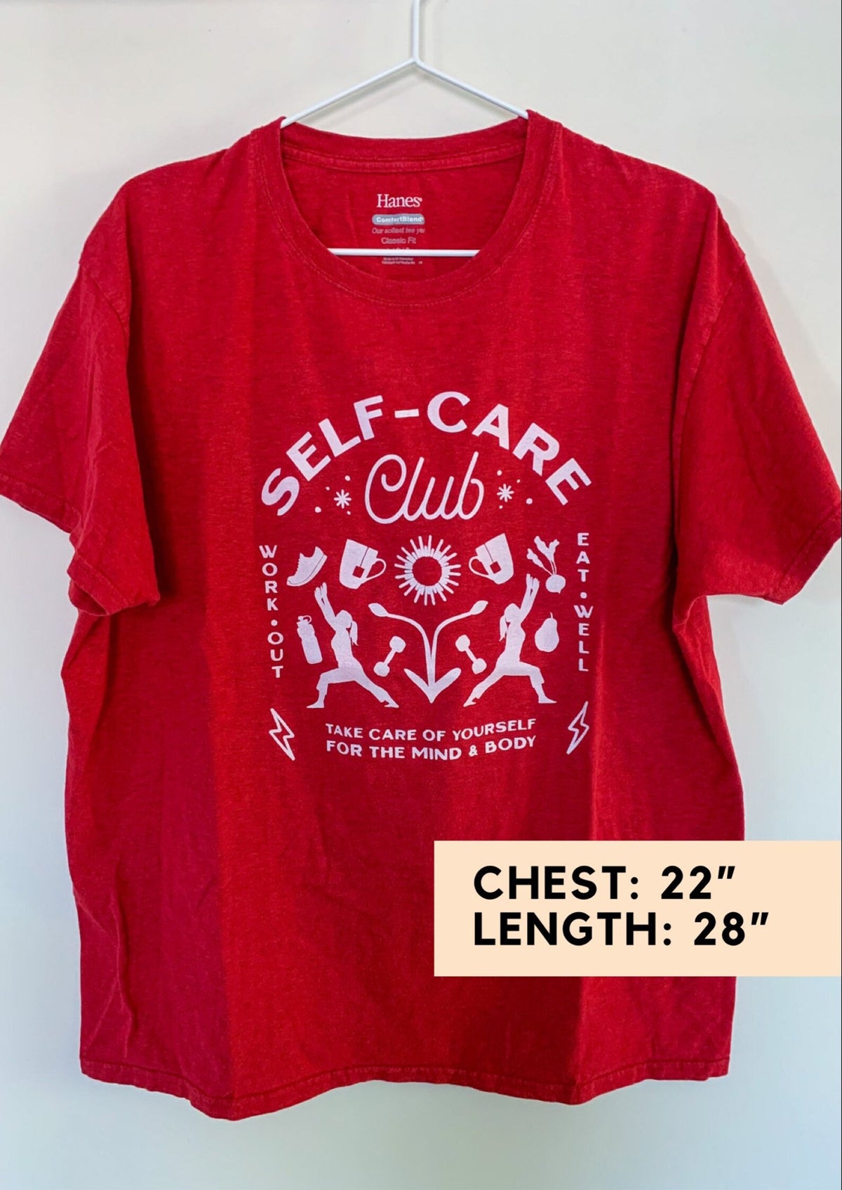 A red t - shirt that says self care club.