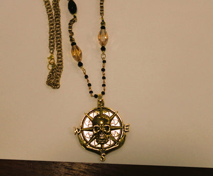 A necklace with a skull and compass on it.