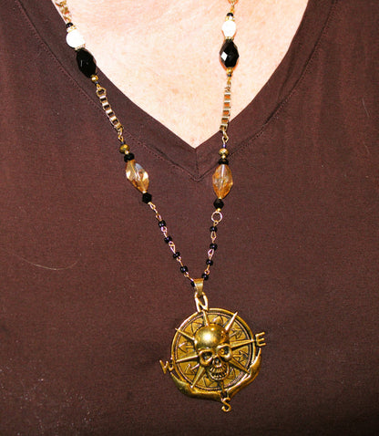 A woman wearing a necklace with a skull on it.