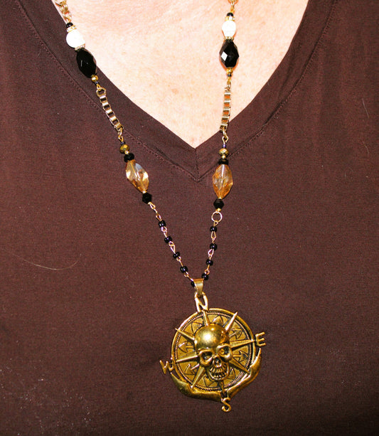 A woman wearing a necklace with a skull on it.