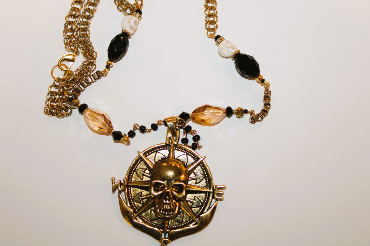 A necklace with a skull and compass on it.