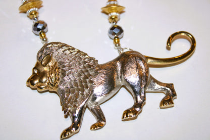A necklace with a silver and gold lion pendant .