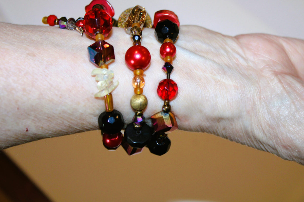 A view of the back of the red beaded bracelet on the wrist