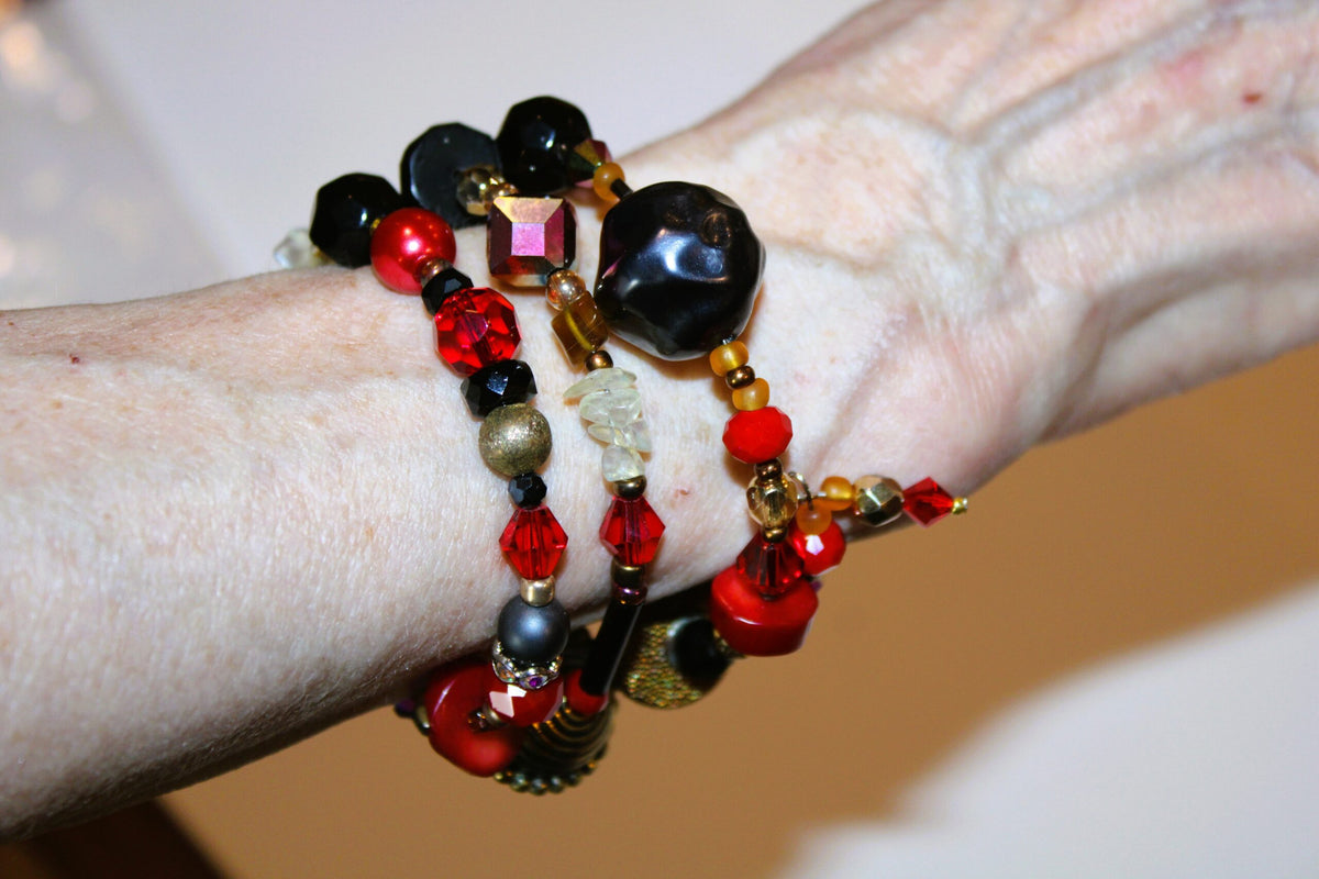 View of red beaded bracelet wrapped around the wrist