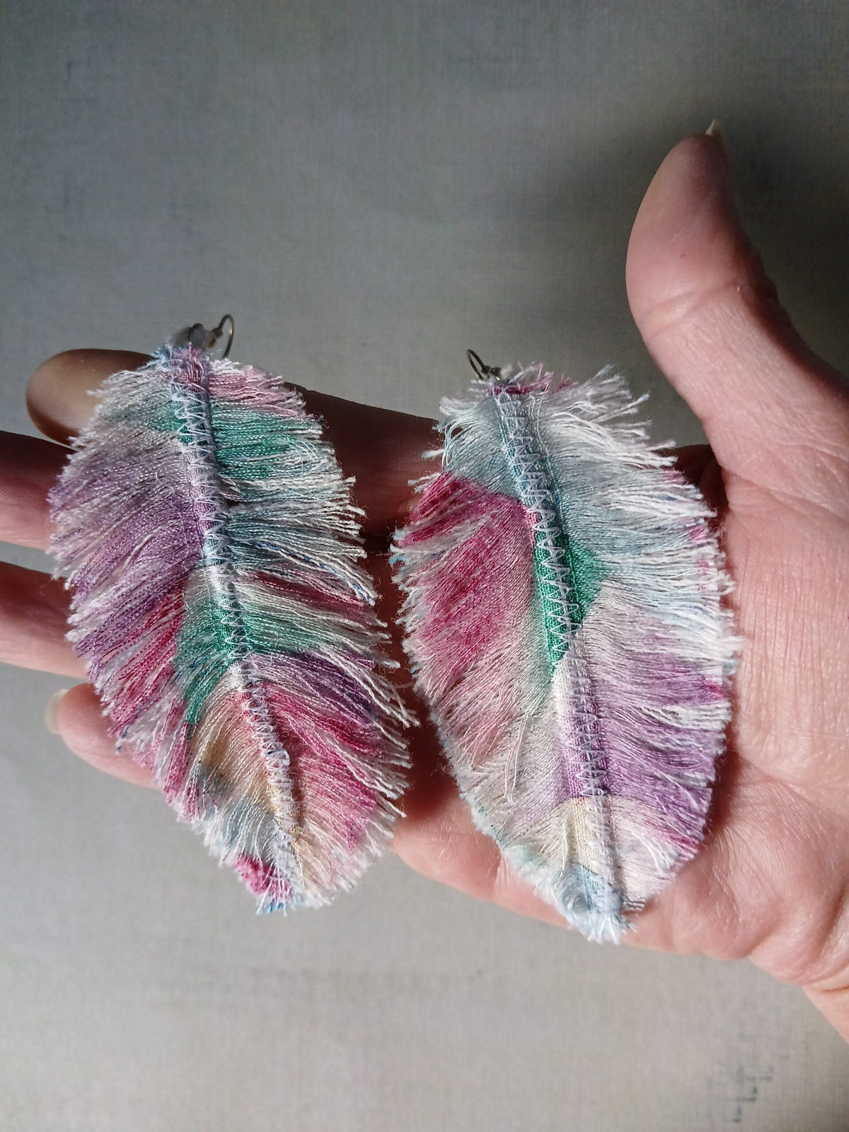 A pair of colorful denim and geometric fabric earrings