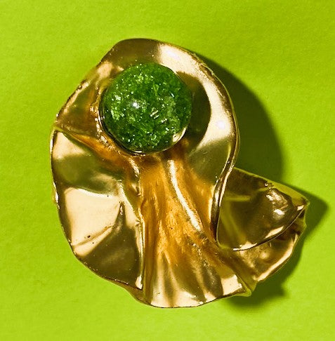 View of one gold tone earring close up