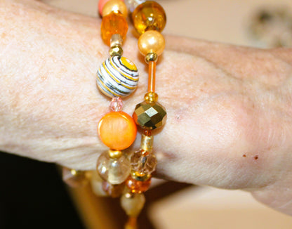 A woman's hand with a bracelet on it.