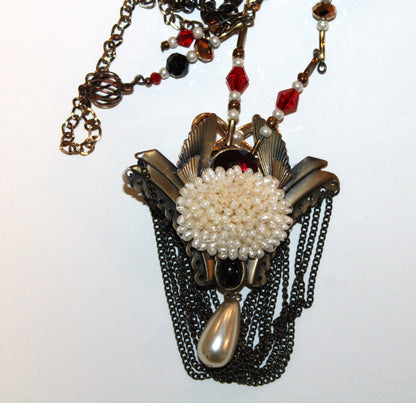 A necklace with a flower on it.