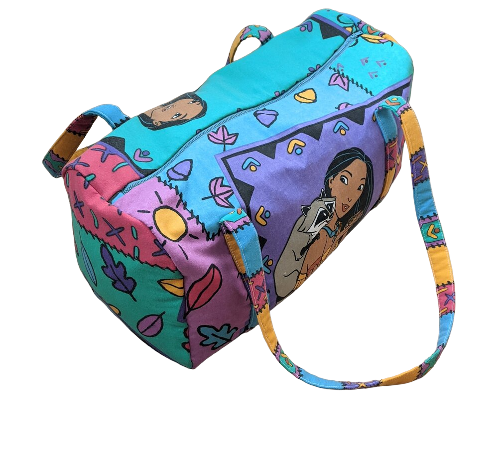 A colorful duffel bag with cartoon characters on it.