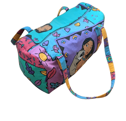 A colorful duffel bag with cartoon characters on it.