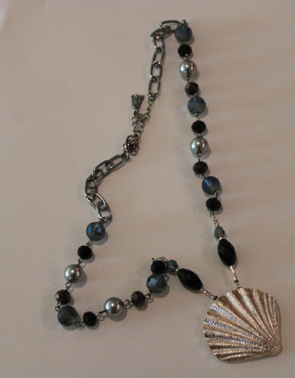 A necklace with a sea shell on it.