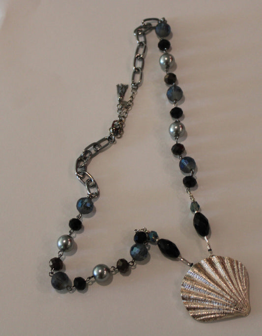 A necklace with a sea shell on it.