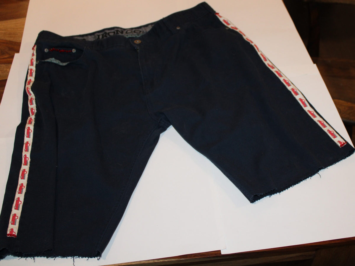 Truck themed denim shorts laying on table
