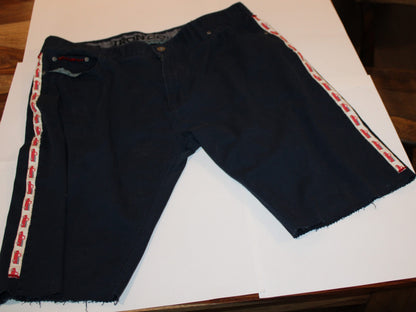 Truck themed denim shorts laying on table
