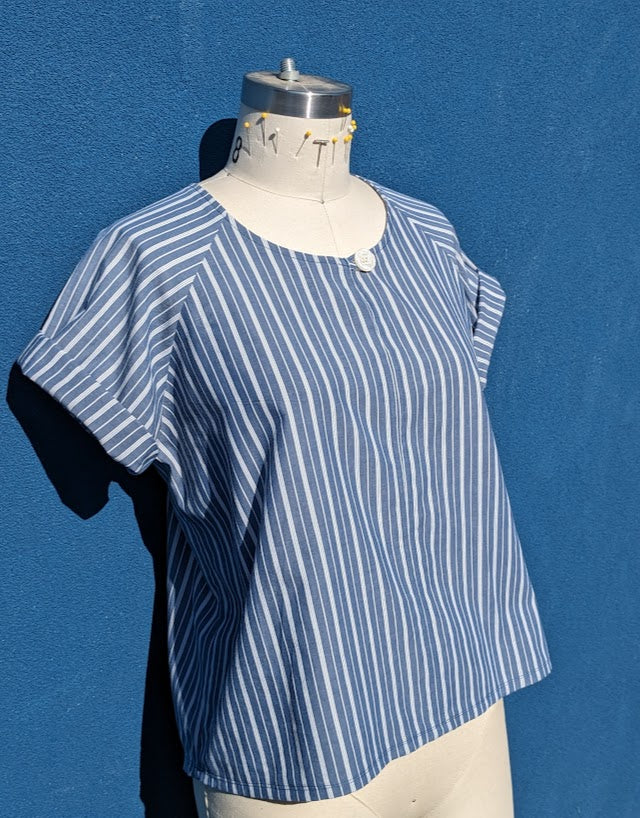 A blue and white striped top on a mannequin.