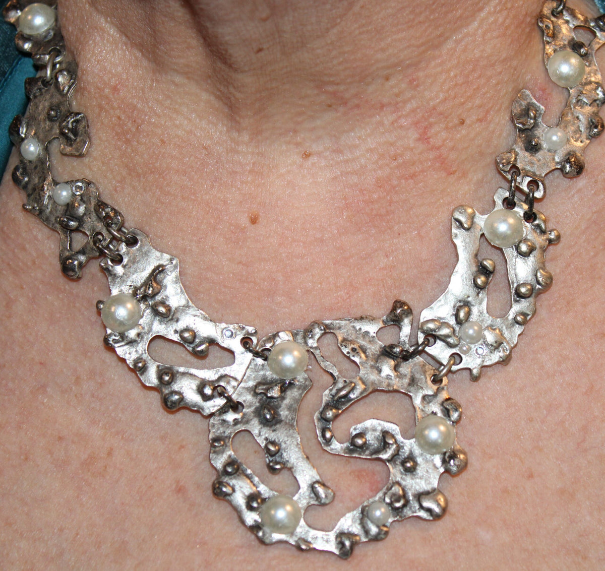 picture of silver tone free form segmented necklace worn with pearls