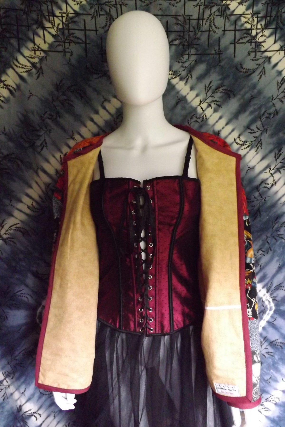 A mannequin wearing a dress and jacket.